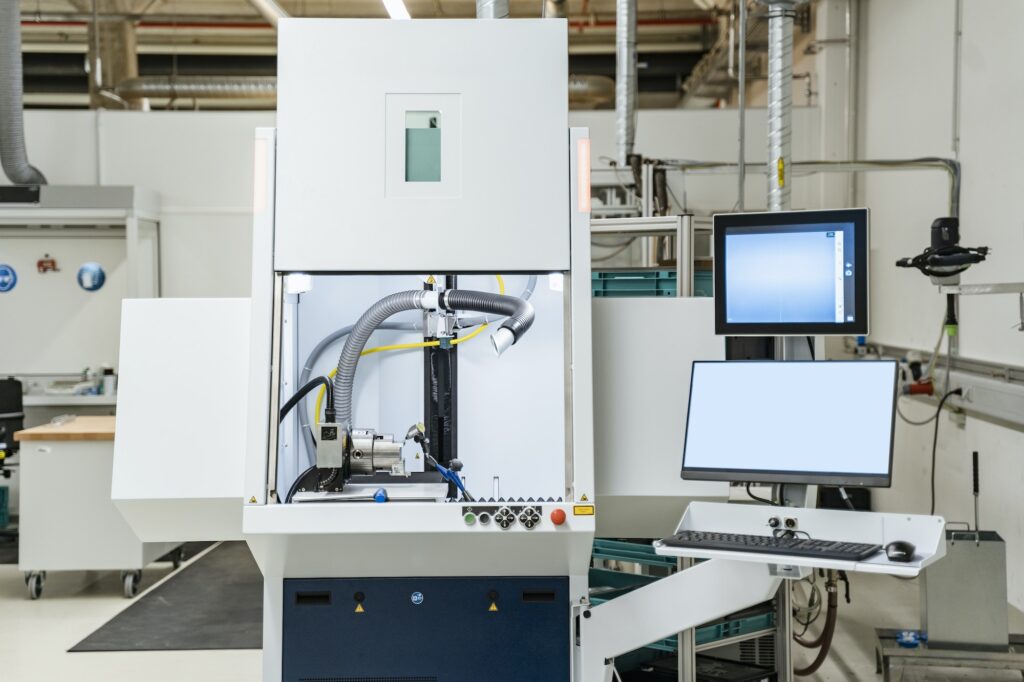 Control station of laser marking system inside modern factory, Stuttgart, Germany